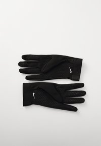 Black athletic gloves made of stretchy fabric, featuring a textured grip pattern on palms, a snug cuff, and a small white Nike logo.