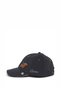 Black cap with curved brim, embroidered butterfly graphic on front, and "Queen" text in silver. Features contrast stitching and adjustable strap.