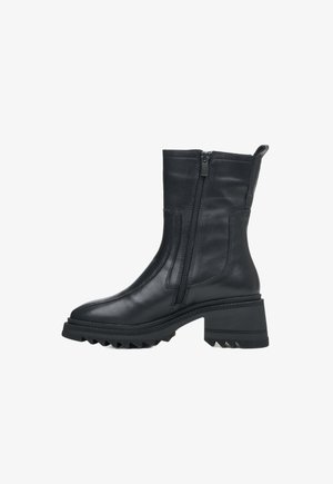 Black leather ankle boot with a smooth finish, side zipper, and ribbed heel detailing. Chunky sole with traction features.