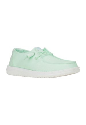 Light green fabric shoe with a rounded toe, lace-up design, and a white rubber sole. Smooth texture with subtle stitching details.