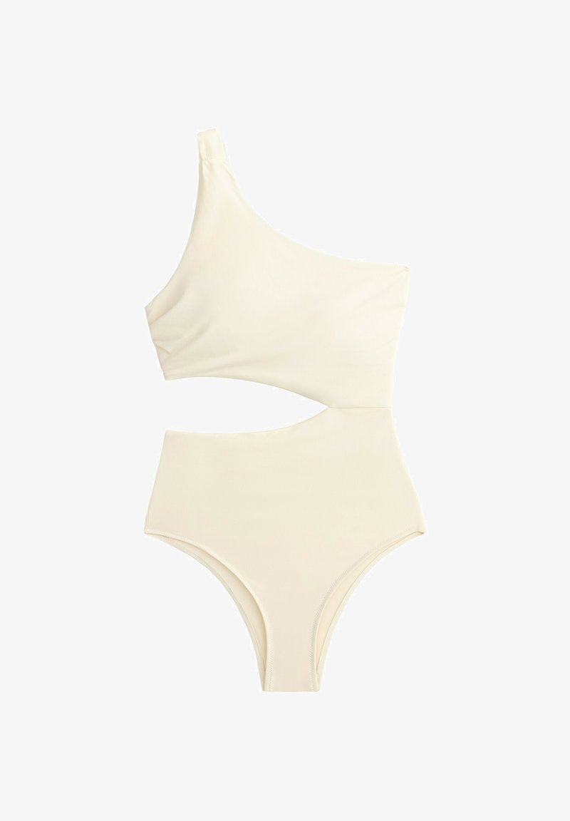 Maillot de bain une pièce ivoire asymétrique avec découpe au niveau de la taille et jambes hautes.