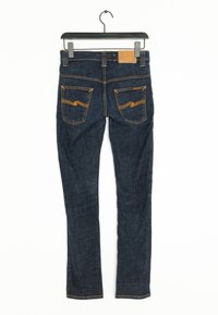 Mörkblå denim skinny jeans med orange sömmar, två bakfickor med ett zigzagmönster och en beige tygskylt på midjan.