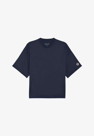 T-shirt à manches courtes surdimensionné bleu marine avec col rond et petit logo circulaire sur la manche gauche.
