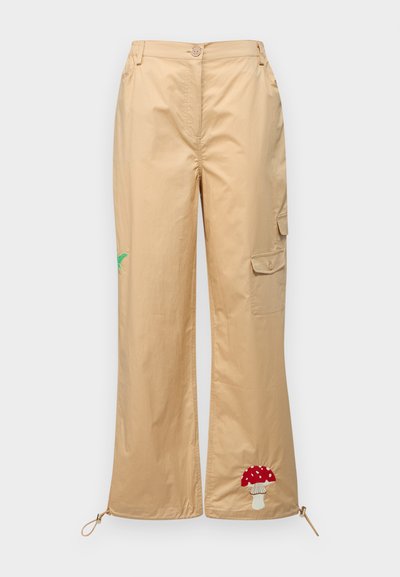Beige cargo pants made from smooth fabric, featuring an embroidered mushroom and palm leaf, adjustable hem, and side pockets.