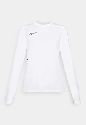 Long-sleeve white athletic shirt made of breathable fabric, featuring a black Nike swoosh logo on the upper left. Smooth texture, fitted design.