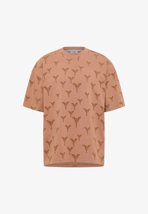 Růžové bavlněné oversized tričko s opakujícím se hnědým abstraktním vzorem, žebrovaným kulatým výstřihem a krátkými rukávy.