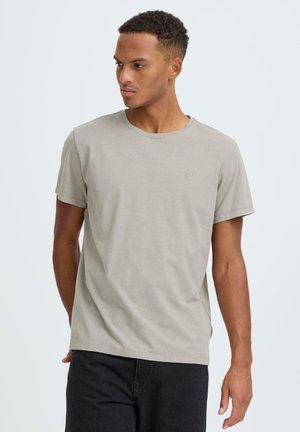 Lysegrå bomuld T-shirt med rund halsudskæring, korte ærmer og et lille logo på brystet. Blød tekstur og afslappet pasform.