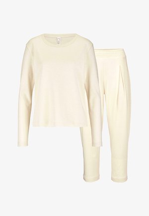 Top a maniche lunghe crema con scollatura rotonda e pantaloni slim-fit coordinati, entrambi in tessuto morbido e liscio con vita elastica.