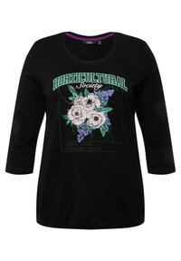 Top de manga larga de algodón negro con un diseño floral que presenta flores blancas y verdes. Texto "Sociedad HORTICULTURAL" en impresión bold y colorida.