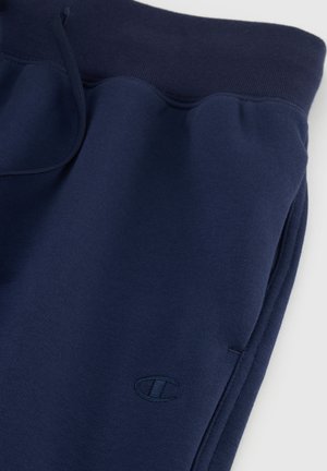 Marineblaue Sweatpants aus einem weichen Stoff, mit elastischem Bund, Kordelzug und kleinem Logo auf dem linken Oberschenkel.