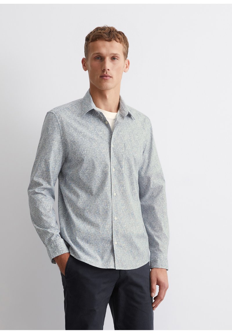 Light blue patterned button-up shirt made of fabric with a subtle texture. Features a collar, long sleeves, and a chest pocket.