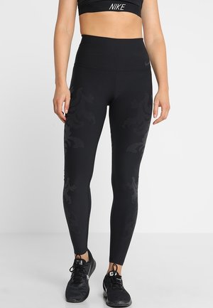 Sorte højtaljede leggings med en glat tekstur og subtilt mønster. Har Nike branding og tætsiddende design til aktivt brug.