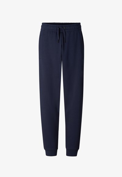 Granatowe spodnie dresowe z elastycznym paskiem w talii, sznurkiem do związania, bocznymi kieszeniami i ściągaczami przy kostkach.