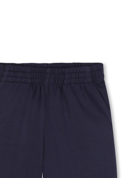 Navyblauwe joggingsbroek met een elastische tailleband, een gladde textuur en zijzakken. Eenvoudig ontwerp zonder zichtbare patronen of beslag.