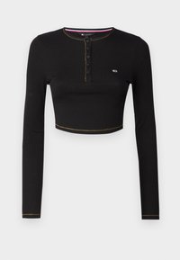 Sort langærmet cropped top lavet af ribbet stof. Har en rund halsudskæring med knaplukning og kontrasterende guld syning.