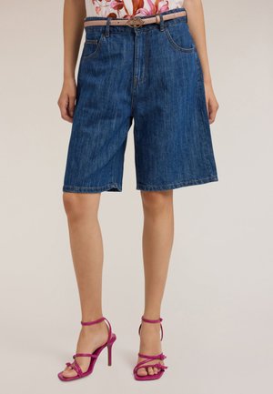 Shorts en denim Bermuda de color bleu moyen, avec une coupe décontractée, des poches frontales et une ceinture avec une boucle ronde.