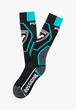 Ponožky ke kolen v černé barvě s tyrkysovými akcenty, texturovanou šedou patou a bílým logem "ROSSIGNOL" na chodidle. Design s hexagonálním vzorem.
