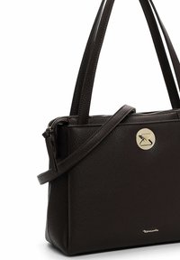 Donkerbruine leren handtas met een gestructureerde afwerking, uitgerust met twee handgrepen, een afneembare schouderband en een metalen logo-accent.