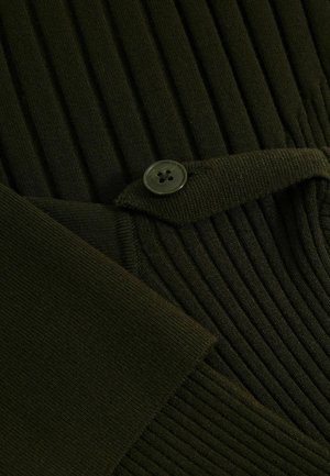 Dark green ribbed fabric featuring a textured pattern, with a round green button and a folded section. Soft texture and structured design.