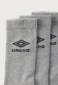 Γκρι ριγέ κάλτσες με απαλό υφή, με μαύρο λογότυπο "Umbro" και διαμαντένιο σχέδιο στο πλάι.