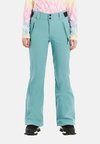 Svetlo modré lyžiarske nohavice so strihom rovného nohu, s vreckami na zips a nastaviteľným pásom. Hladká tkanina s jemným leskom.