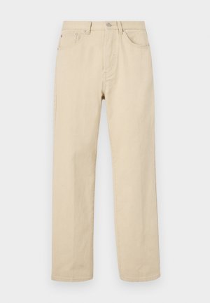 Beige cotton straight-leg jeans with a button closure, five pockets, and subtle stitching. Smooth texture and minimal detailing.