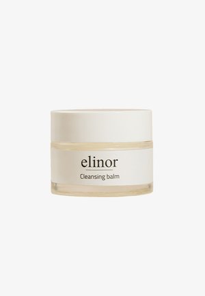 Pyöreä lasipurkki valkoisella muovikannella, jossa on mustalla tekstillä etiketti, jossa lukee "elinor Puhdistusbalsami". Säilynyt kirkas balsami näkyy purkin sisällä.