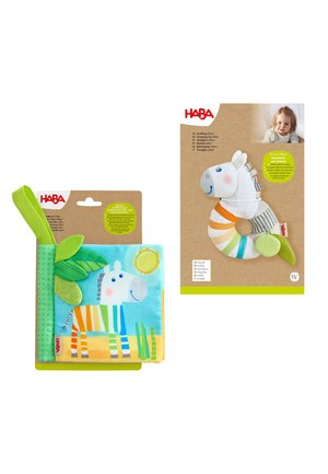 Colorful zebra fabric baby book and a soft striped zebra toy with packaging and baby photo on a white background.