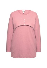 Maglietta a maniche lunghe rosa con scollatura rotonda, caratterizzata da un sovrapposizione unica e tre bottoni sul petto. Realizzata in un tessuto morbido e leggero.
