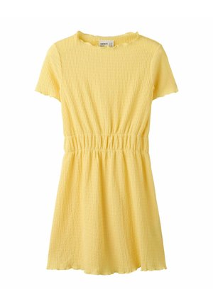 Trumpa geltona tekstūruota su trumpomis rankovėmis su elastingu juosmeniu ir šiek tiek raukšlėtu apačia bei iškirpte.