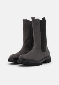 Gray suede ankle boots with elastic side panels, rounded toe, and textured black rubber sole. Zipper detail on the side.
