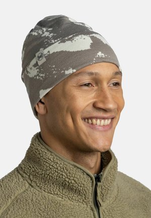 Gray and white patterned knit beanie with Buff logo, worn by a person, featuring a close-fitting design and soft texture.