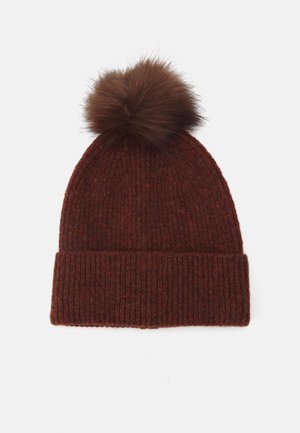 Knitted beanie in deep brown with a ribbed texture and a plush brown fur pom-pom on top. Cuffed design for added warmth.