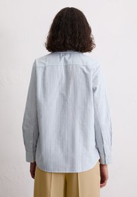 Blauw-wit gestreept overhemd met lange mouwen, rechte zoom en omgeslagen manchetten, gemaakt van een lichte stof.