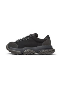 Black athletic sneaker with a textured sole, featuring sturdy laces and a reinforced toe, designed for comfort and durability.