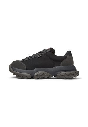Black athletic sneaker with a textured sole, featuring sturdy laces and a reinforced toe, designed for comfort and durability.