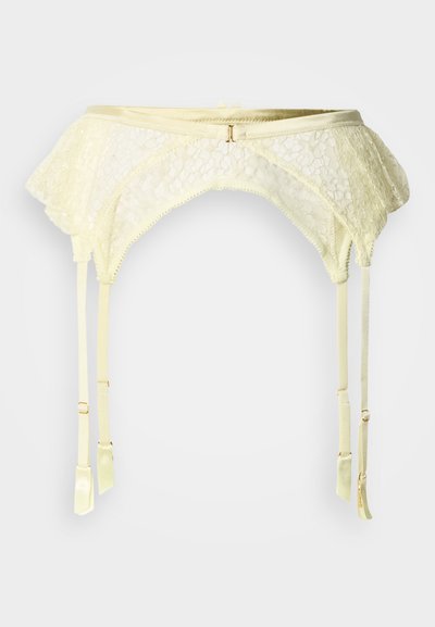 Ζώνη ζαρτιέρας από ελεφαντόδοντο δαντέλα με κυματιστές άκρες, ρυθμιζόμενους ιμάντες και μεταλλικά στοιχεία σε χρυσαφί απόχρωση. Διαθέτει λουλουδάτο μοτίβο και λεία υφή.