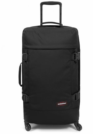 Black wheeled suitcase with a retractable handle, sturdy fabric, side buckles, and a logo patch. Features smooth-rolling wheels for mobility.