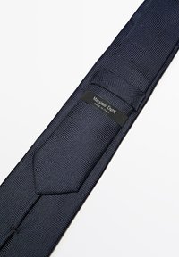 Mørkeblå silkebind med et tekstureret ternet mønster. Har et mærketikette med "Massimo Dutti" og "Made in Italy" på bagsiden.