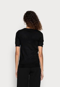 Guess ODETTA - T-shirt estampada - jet black