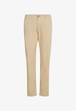 Beżowe spodnie o prostym kroju, z suwakiem i zapięciem na guzik, wykonane z gładkiego materiału z dyskretnymi detalami przeszyć.