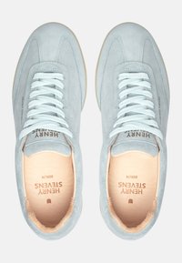 Light blue suede sneakers with white laces, a beige sole, and a smooth interior. Features embossed branding on the side and insole.