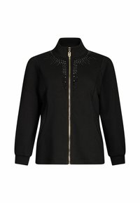 Giacca nera con zip frontale e collo alto, decorata con un motivo di applicazioni nere sul petto. Maniche lunghe e tasche laterali.