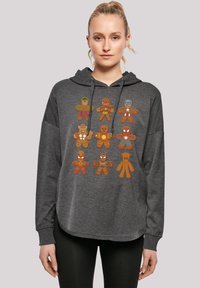 Felpa con cappuccio grigia scura caratterizzata da un design grafico di otto personaggi di pan di zenzero supereroi in vari colori e dettagli. Tessuto texturizzato, vestibilità rilassata.
