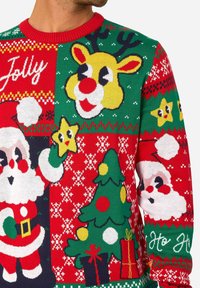 Megztinis Kalėdoms su raudonos ir žalios spalvos deriniu, puoštu Kalėdų Senelio, elnio, Kalėdų eglutės ir žvaigždžių motyvais.