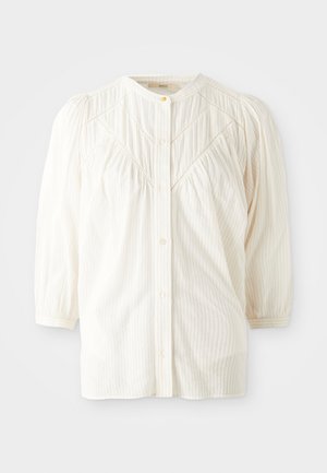 White ribbed button-up blouse with a round collar, pleated shoulders, and long sleeves. Features subtle vertical stripes and a relaxed fit.