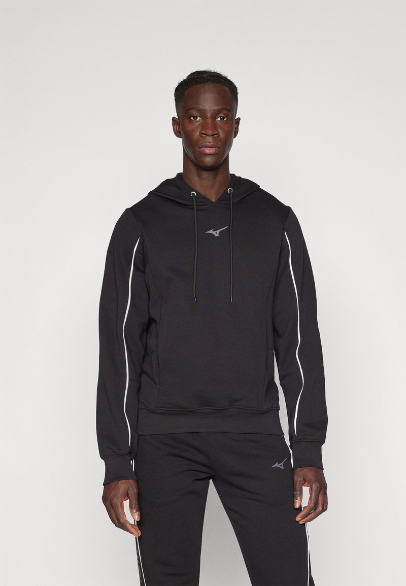 Black hoodie with a drawstring, long sleeves, and white side stripes. Soft material with a logo on the chest and matching black pants.