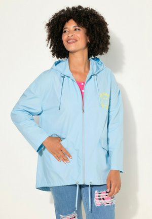 Light blue waterproof jacket with a hood, zip closure, two front pockets, and a yellow smiley graphic on the chest.