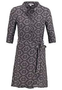 Robe mi-longue à motifs noir et blanc avec manches 3/4, col, devant boutonné et ceinture nouée à la taille.