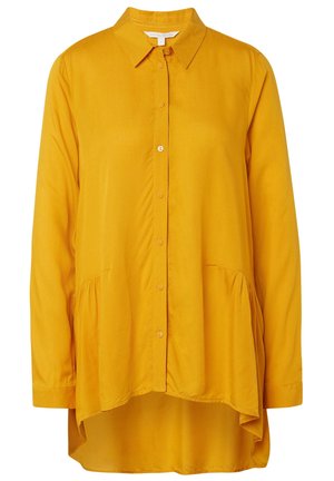 Geel mosterdkleurig overhemd met lange mouwen, knoopsluiting, een spitse kraag en een hoog-laag zoom.